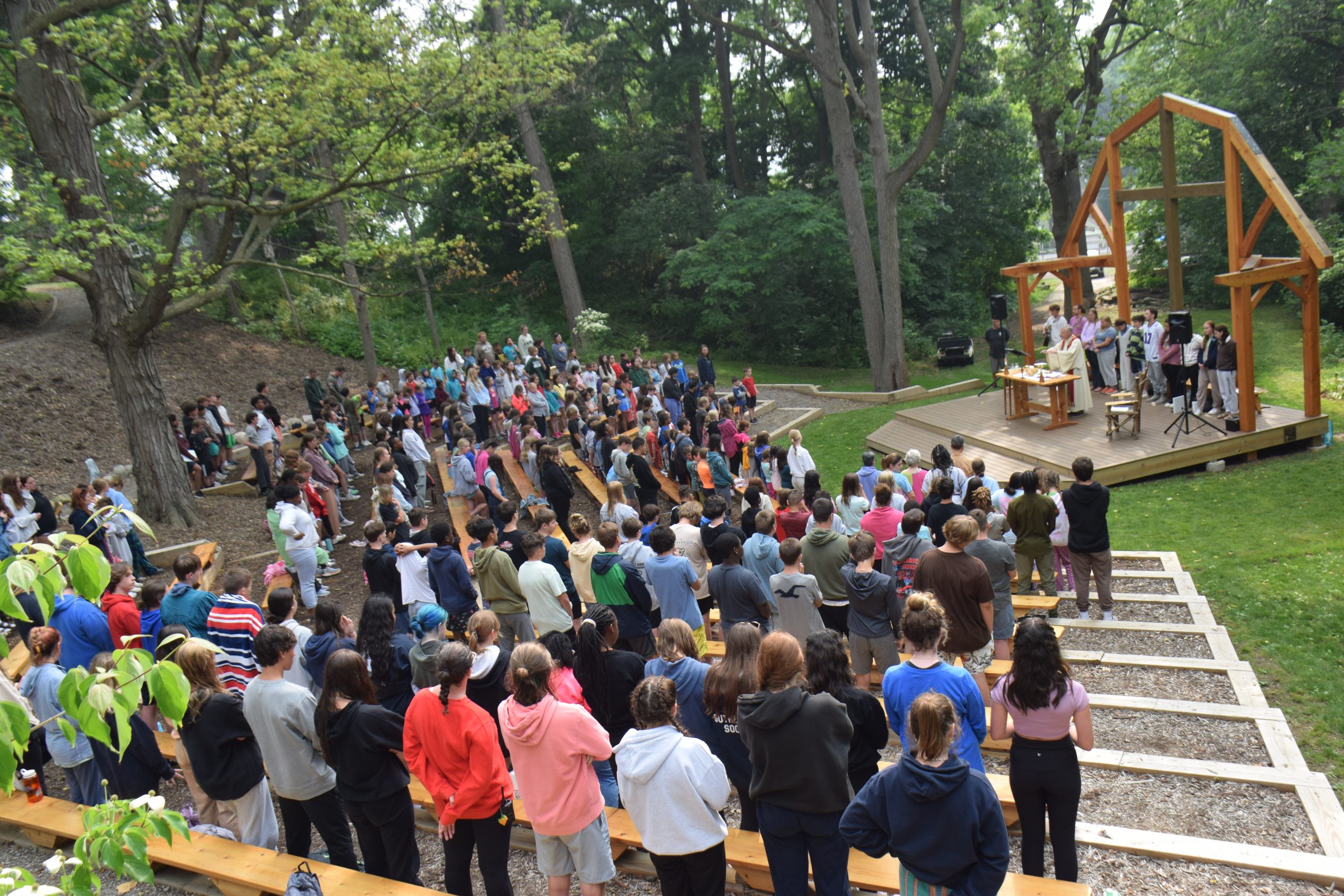 campers participating in a fun mass at an outdoor chapel
