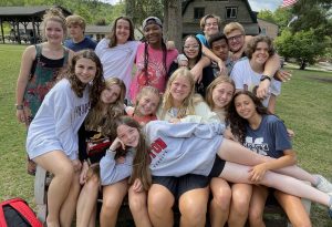 group of male and female teens outside posing for a picture