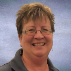 Karen Headshot of Woman with short hair and glasses smiling