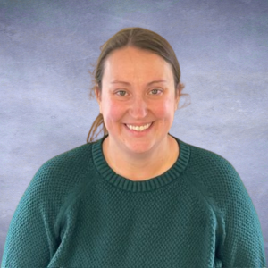 Alicia Headshot of a woman with brown hair pulled back wearing a green sweater