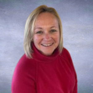 Diane Headshot of a woman with shoulder length blonde hair and a red turtleneck sweater on