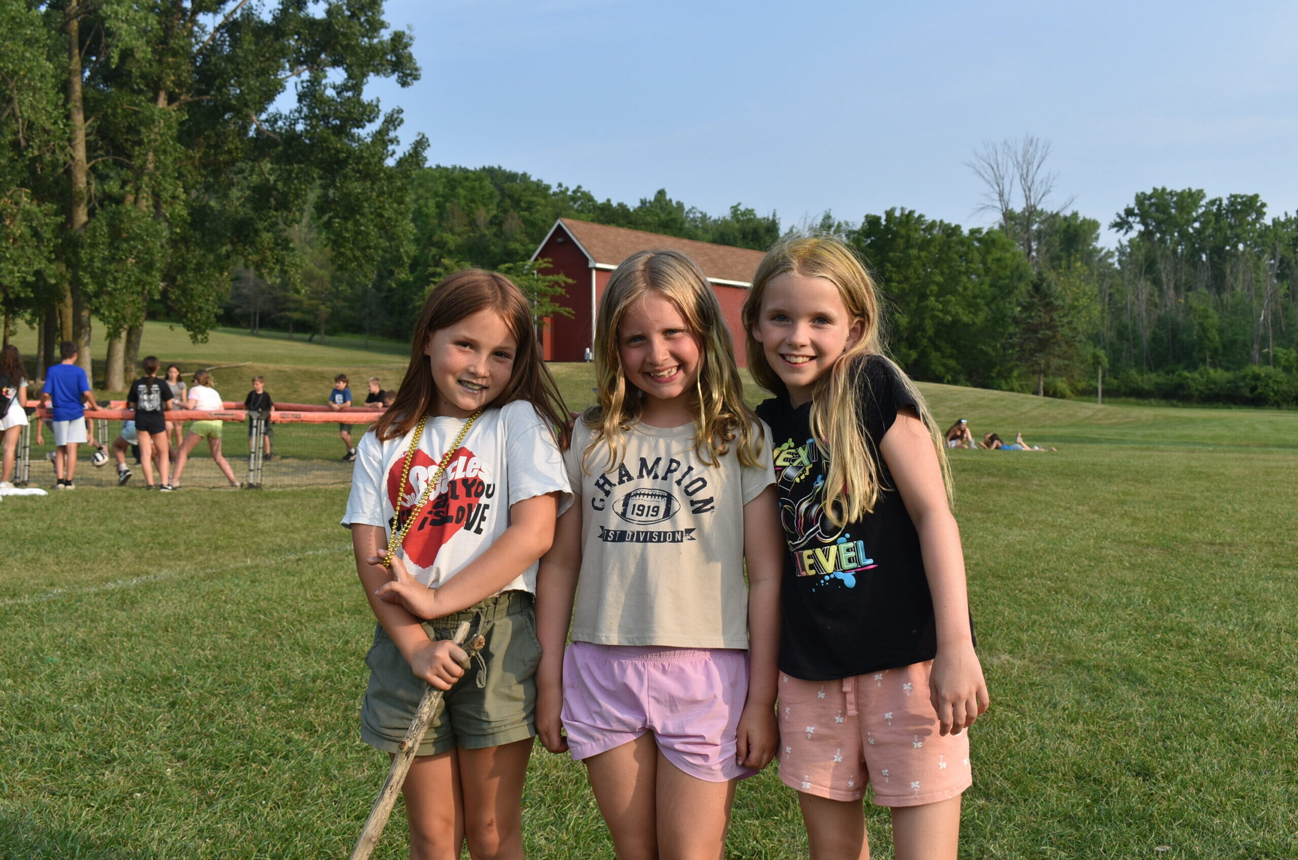 DSC_0310 3 little girls posing for a picture in a field of grass